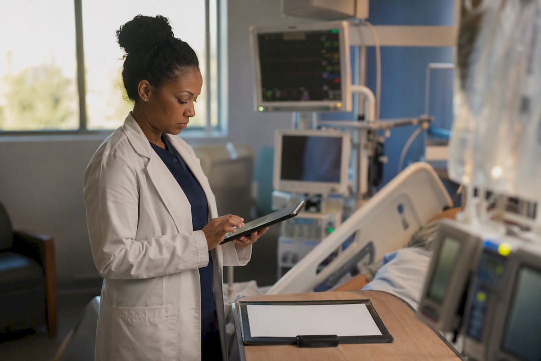 Nurse logging clinical hours at ICU workstation