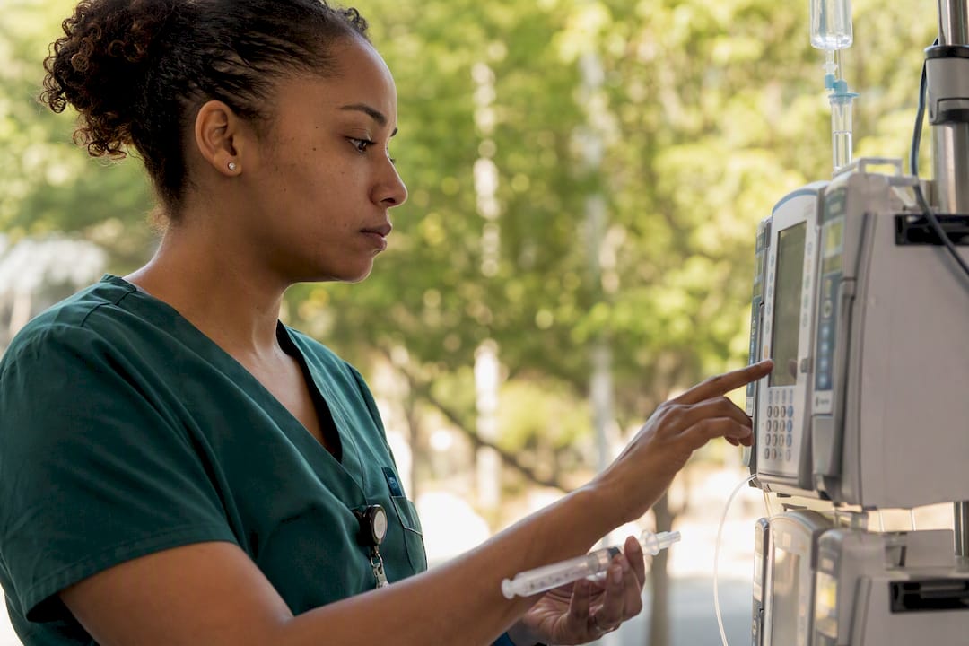 Pediatric ICU nurse preparing medication infusion