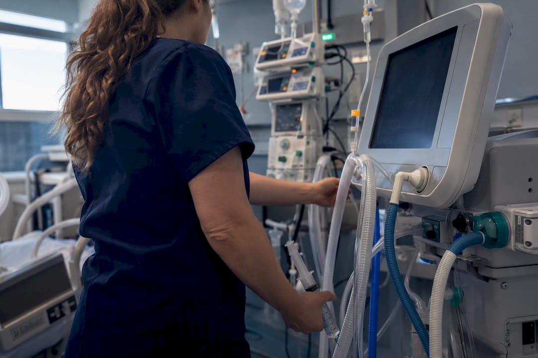 Nurse checking ventilator and ABG in ICU