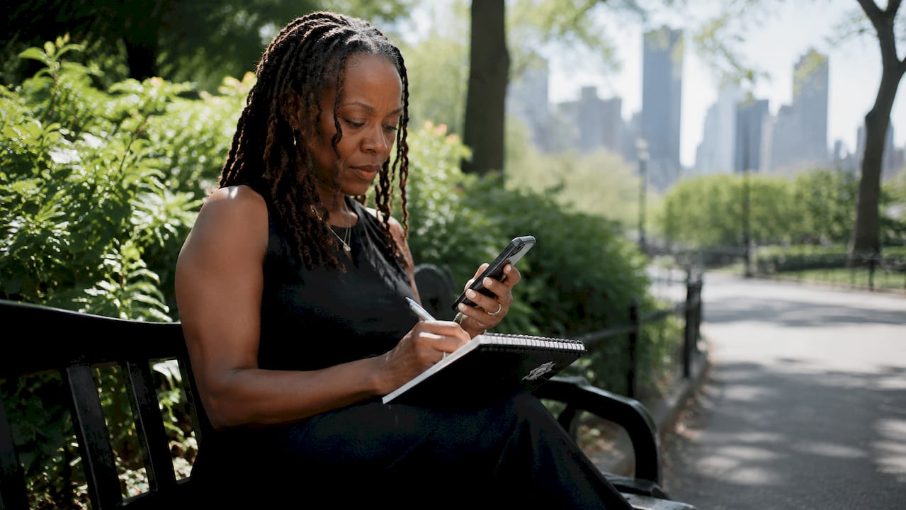 Woman reviewing brand perception notes at cafe