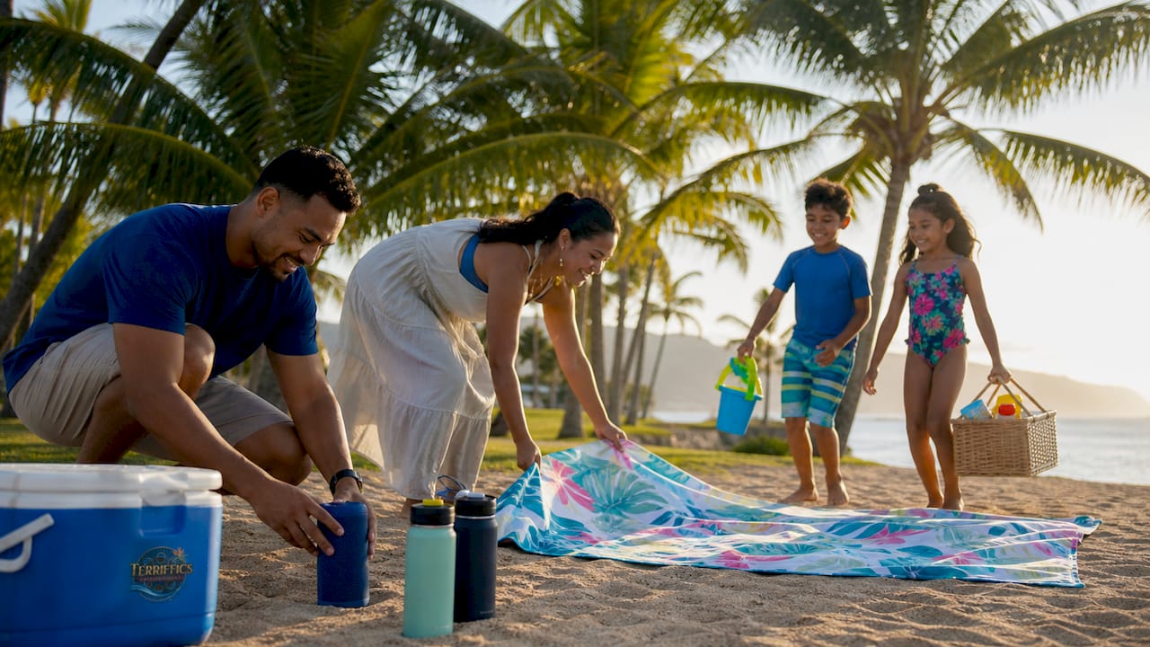 Family preparing picnic setup in Oahu park