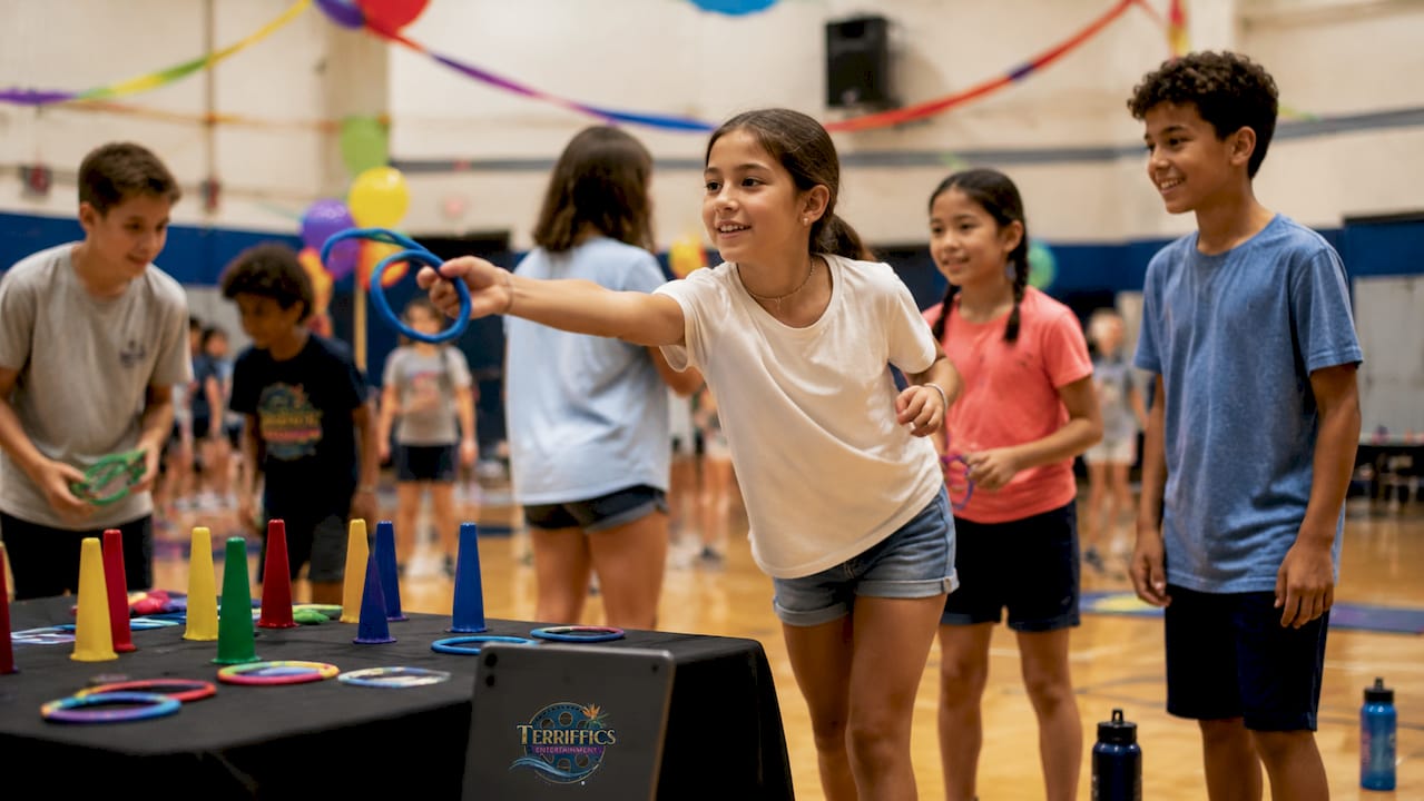 Children playing interactive ring toss at school event