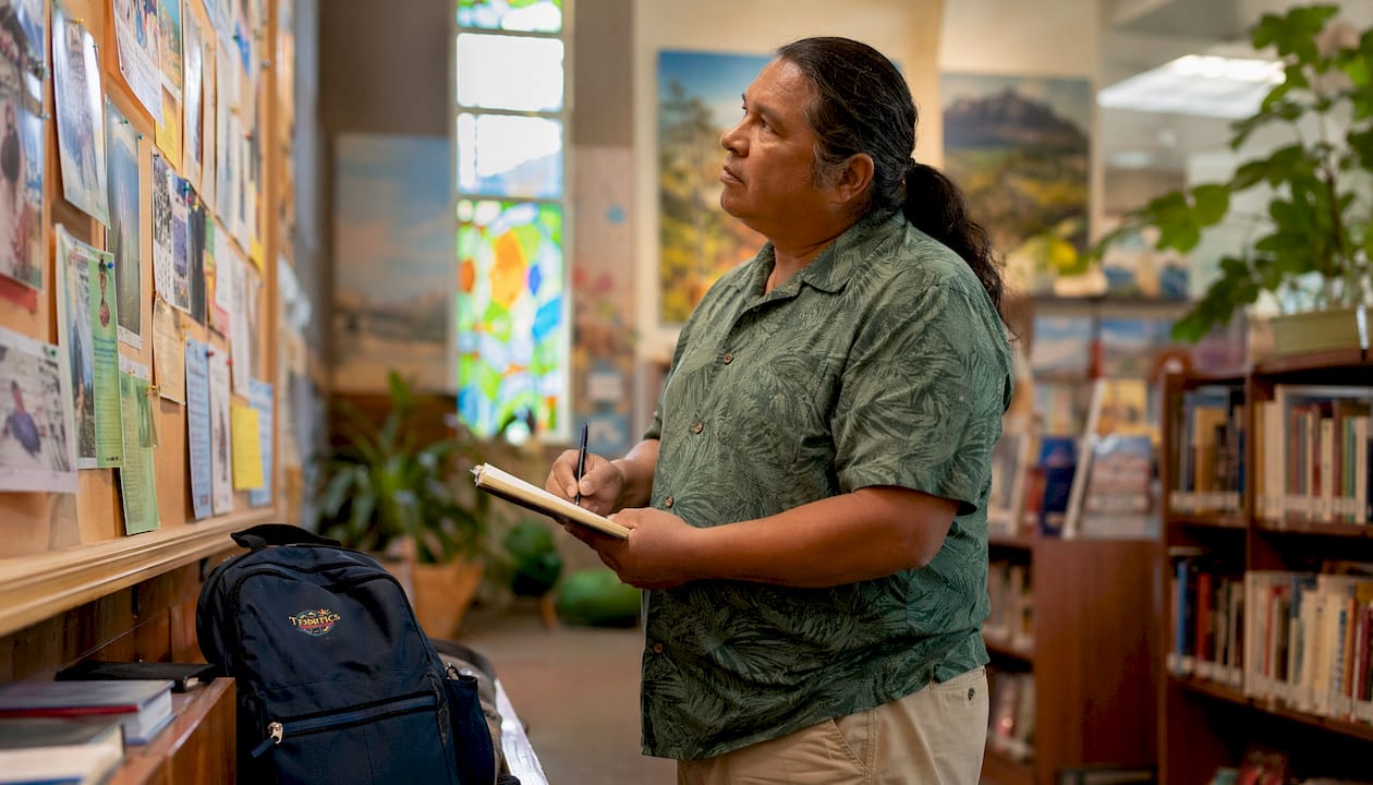 Man checking Oahu library event board
