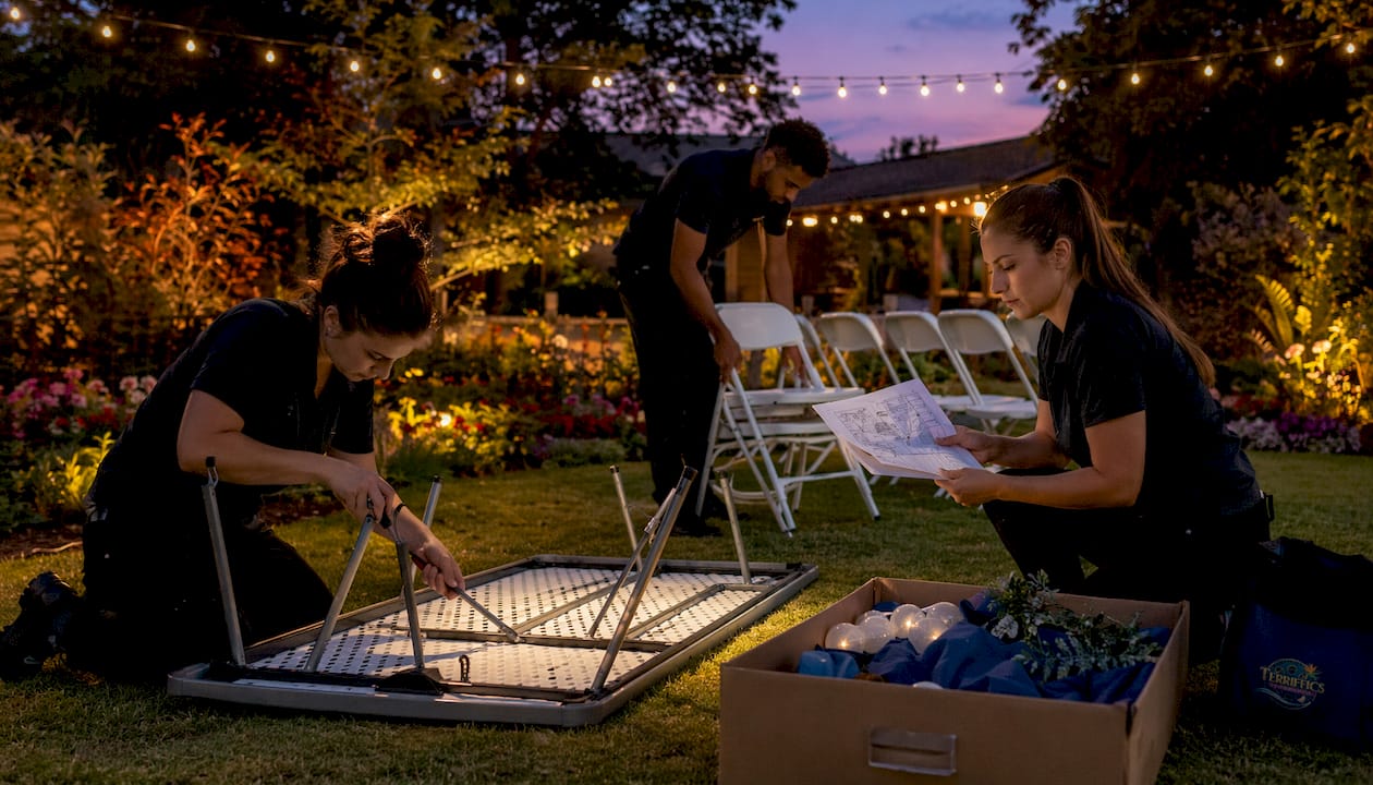 Event setup crew assembling furniture indoors