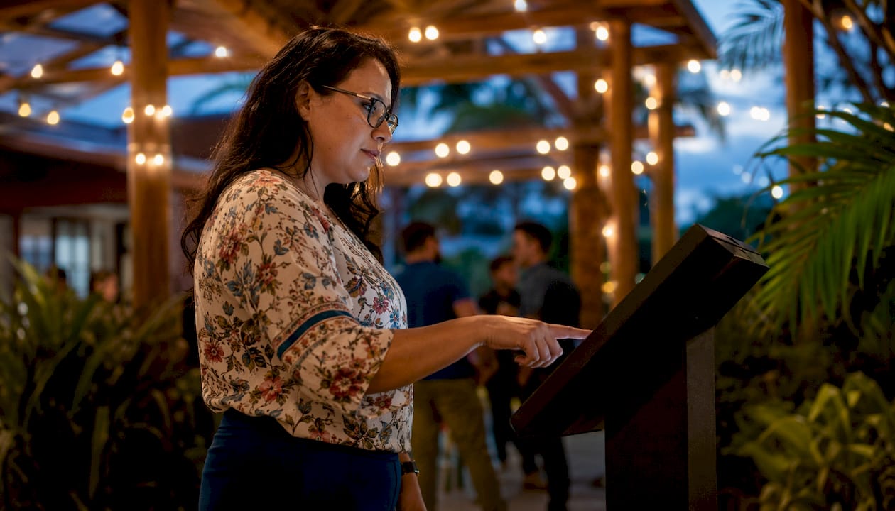 Woman using interactive touchscreen at event