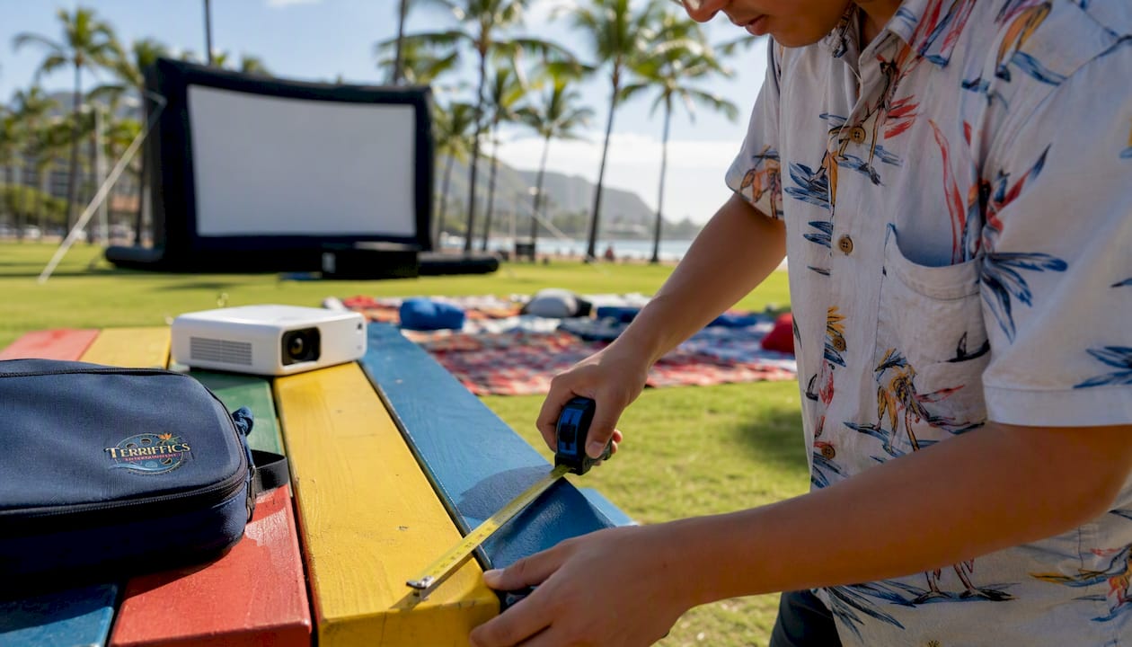 Hands measuring outdoor movie screen size in backyard