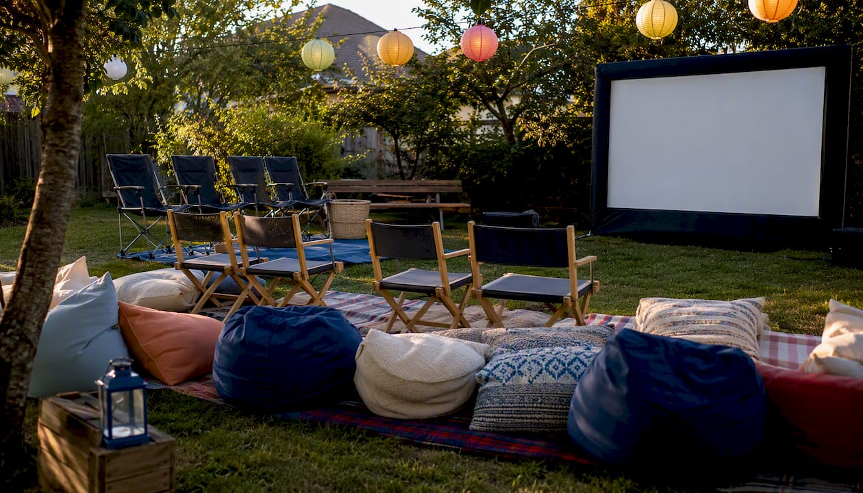 Tiered backyard movie seating with cushions and chairs