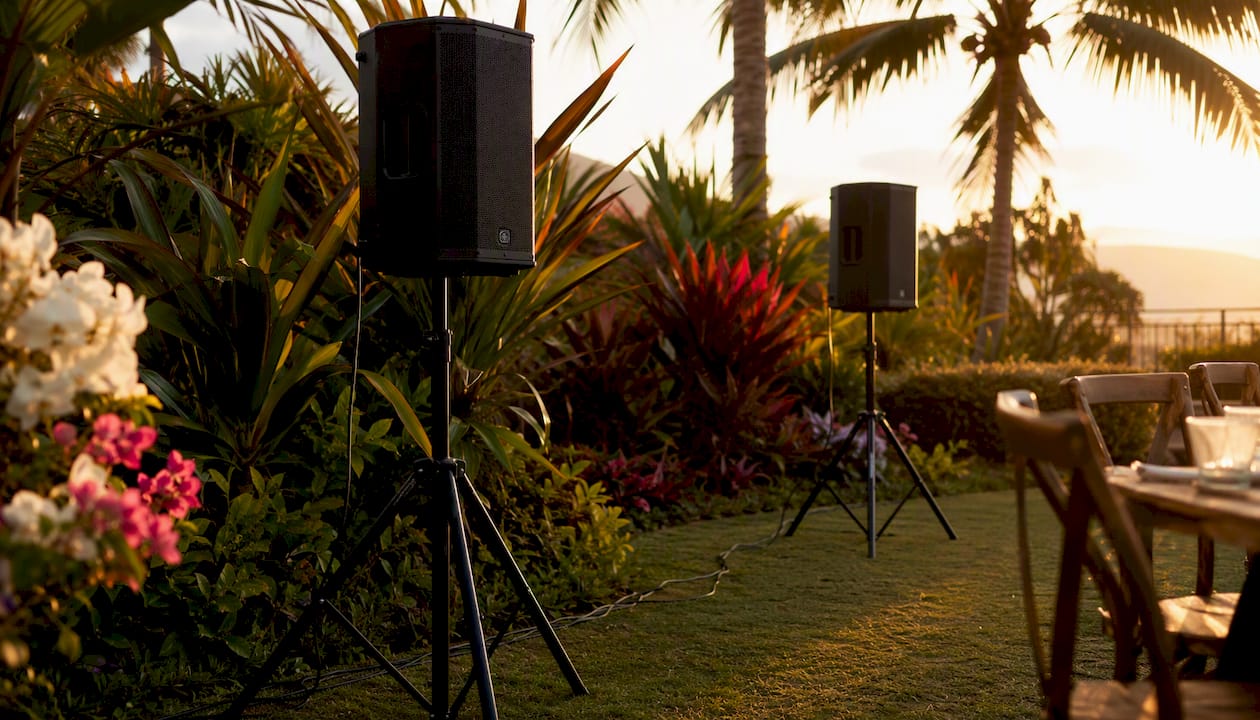 Outdoor backyard speaker setup with tropical plants