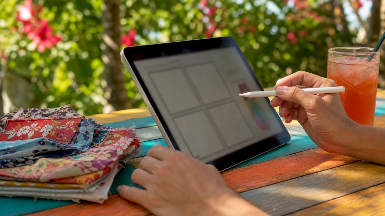Hands editing photo booth template on tablet