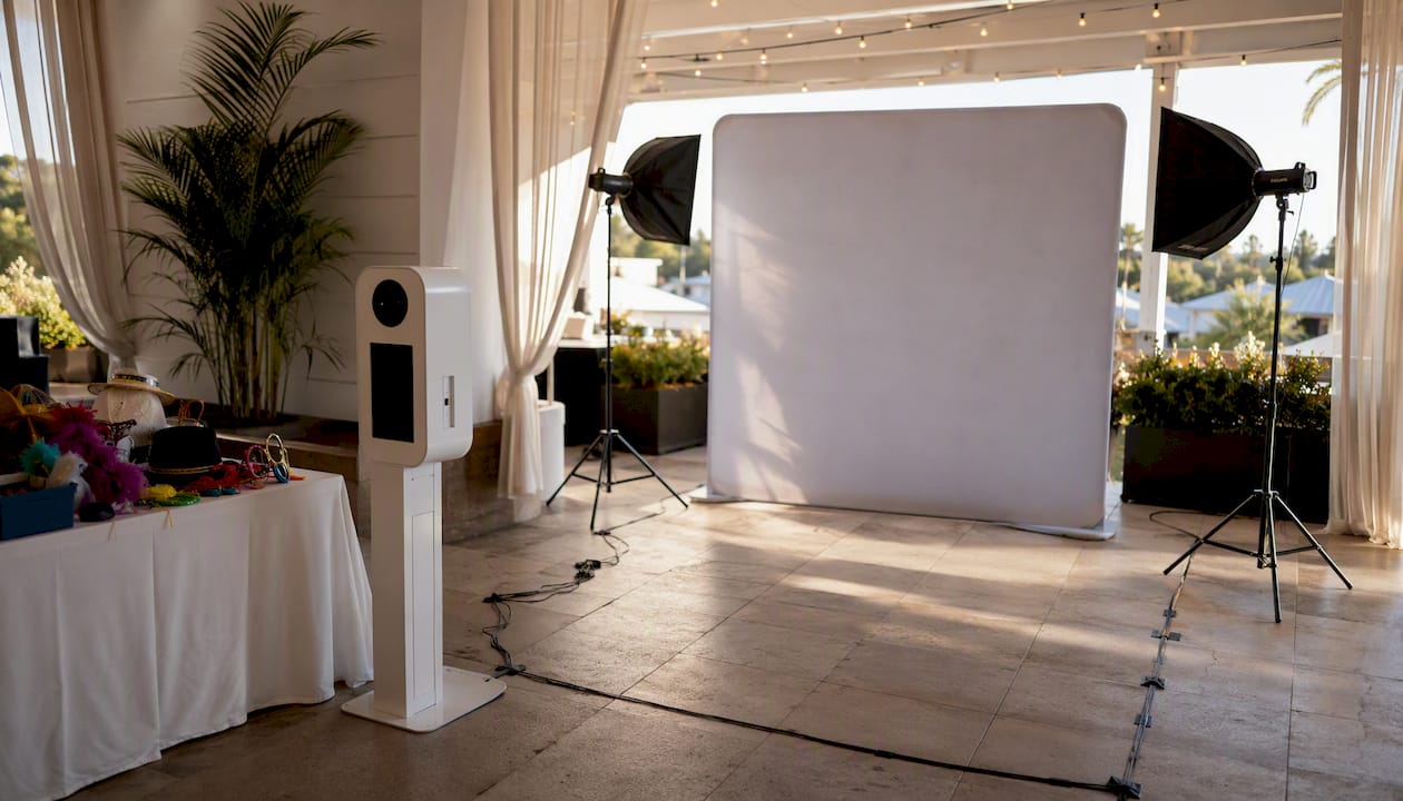Indoor photo booth setup with backdrop and lighting stands