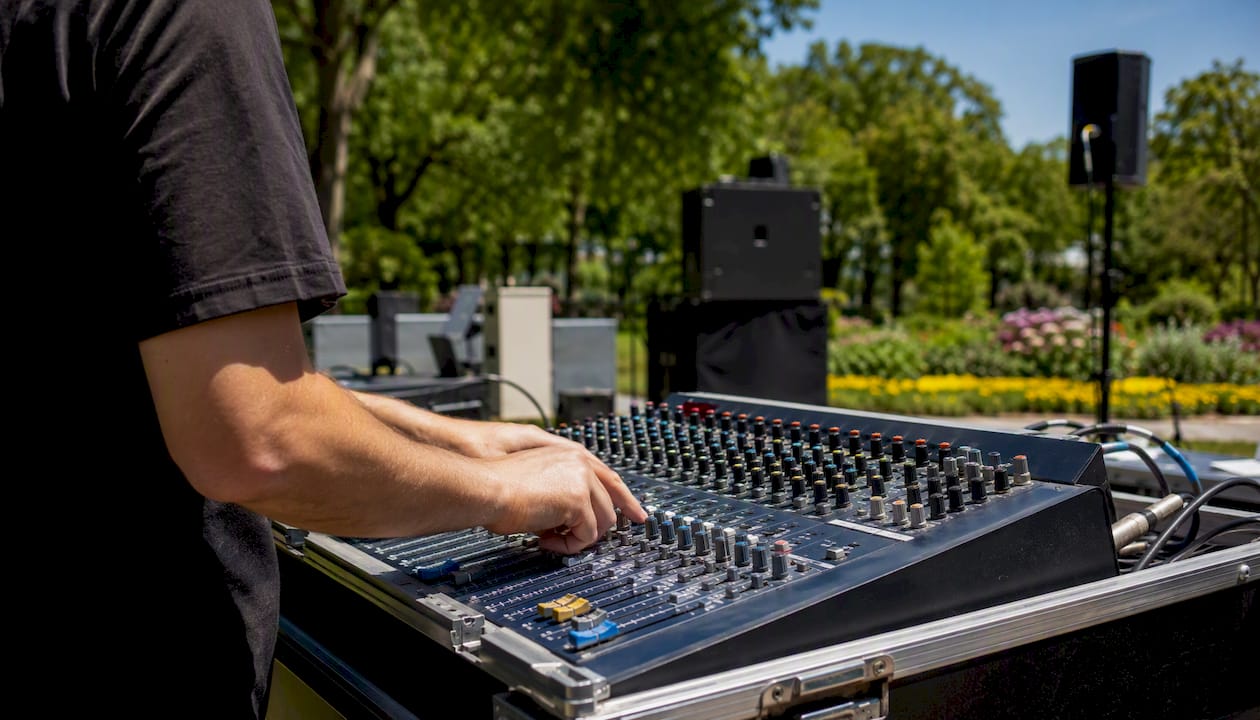 Technician adjusting outdoor sound mixer
