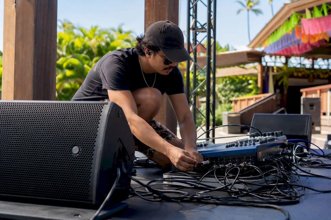 DJ adjusting sound equipment before event