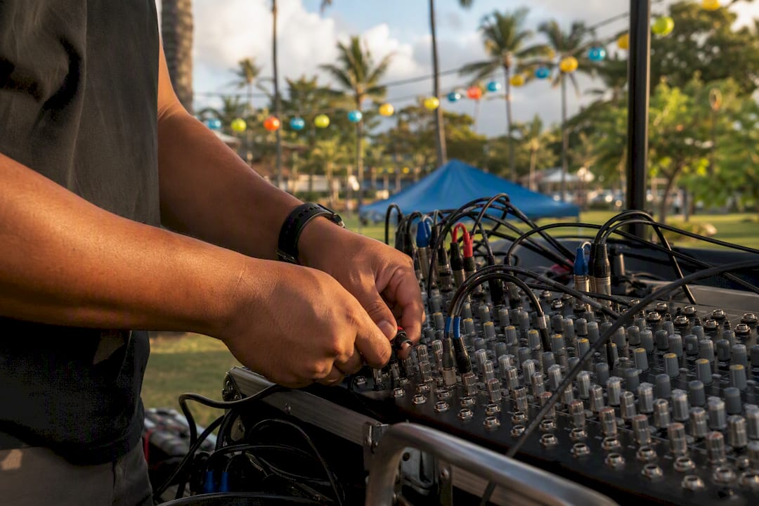 DJ hands connecting mixer cables