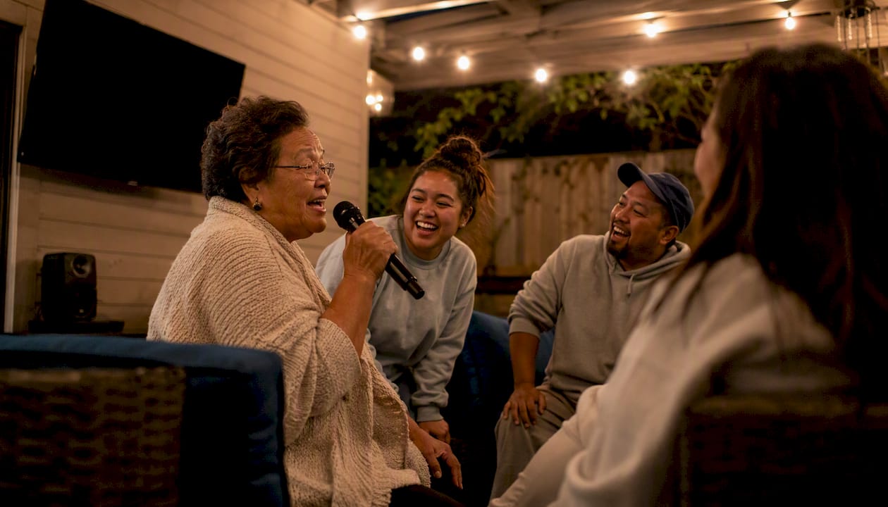 Multi-generation family singing karaoke indoors