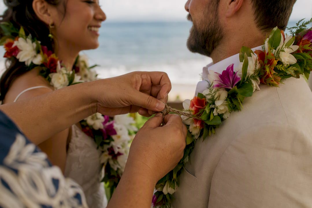 Hands tying closed lei symbolizing union