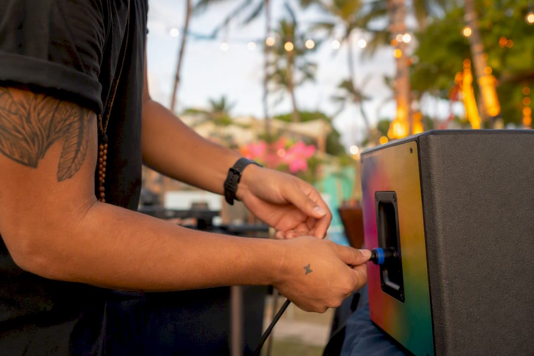DJ hands connecting speaker cable