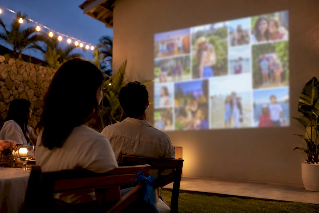Graduation slideshow projected at backyard party