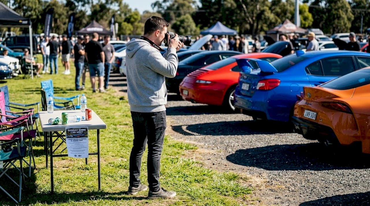 Photographer capturing highlights at car meet event