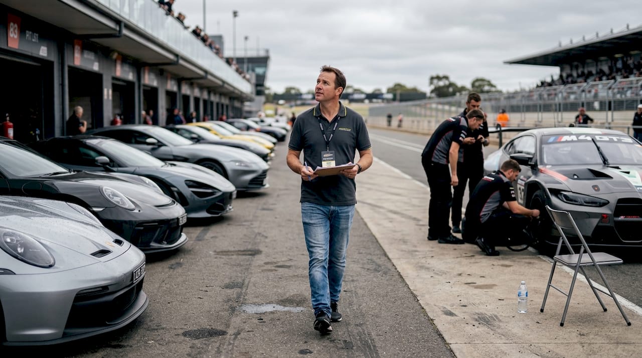 Coordinator walking pit lane at car event