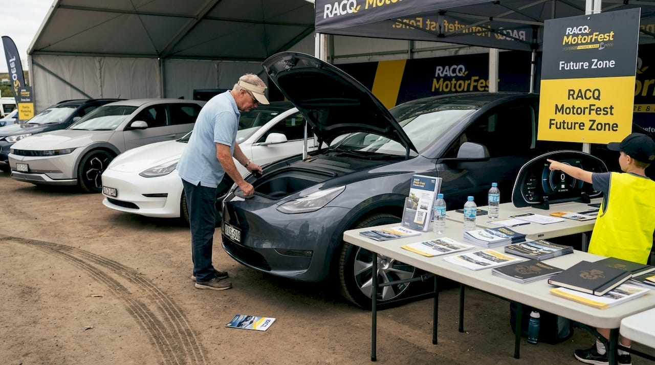RACQ MotorFest attendee inspects electric vehicle