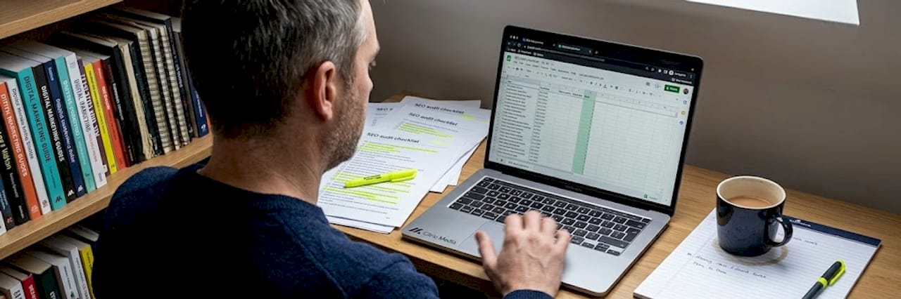 Marketer using SEO audit toolkit at desk