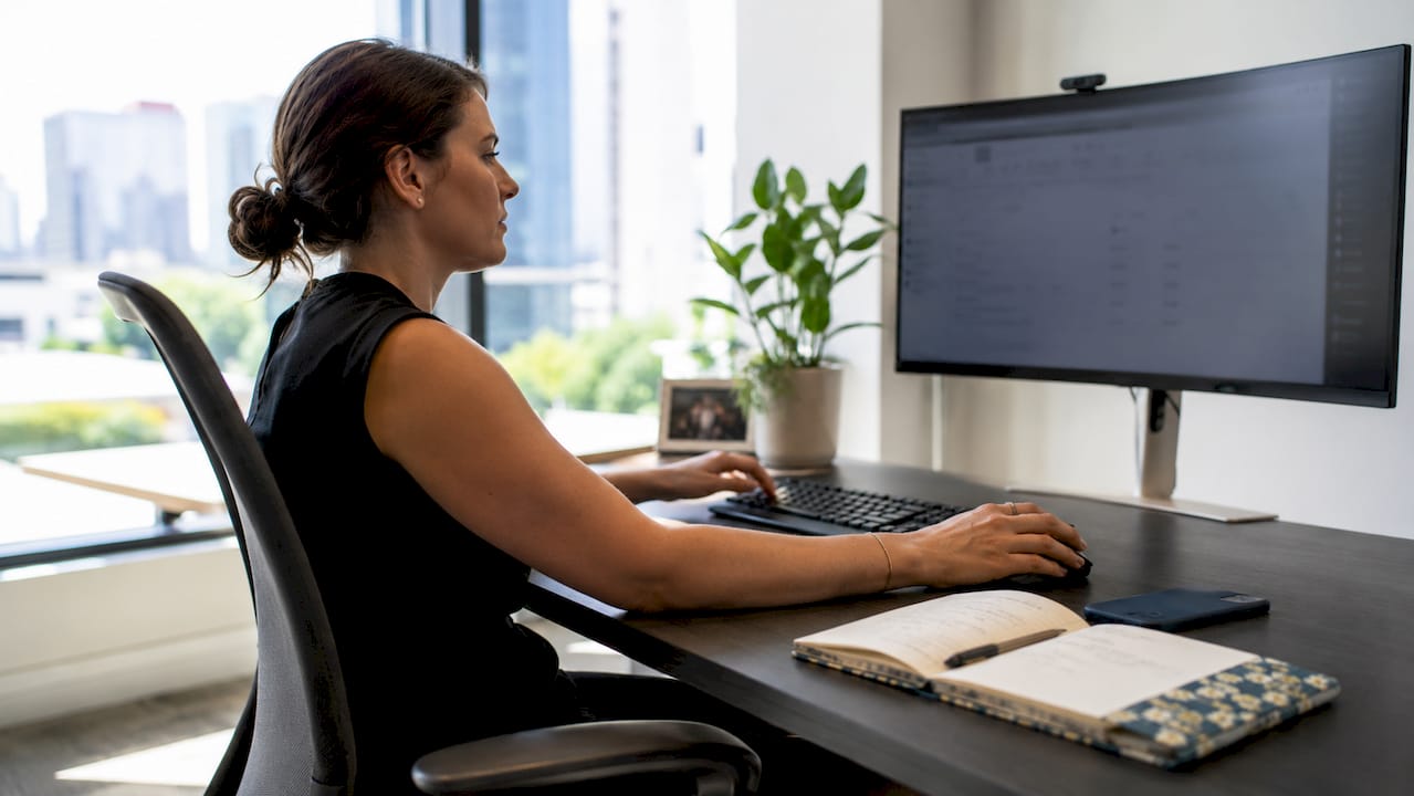 Hands adjusting Bing ads targeting settings on desktop