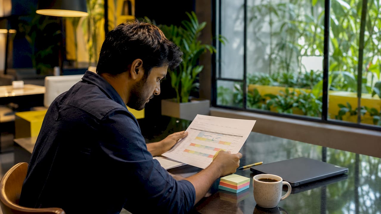 Overhead view of marketing execution timeline and hands with pen
