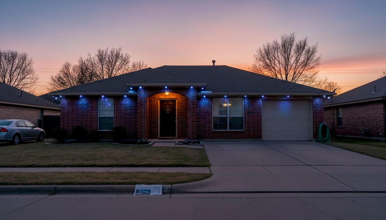 Suburban home with jellyfish lighting at dusk