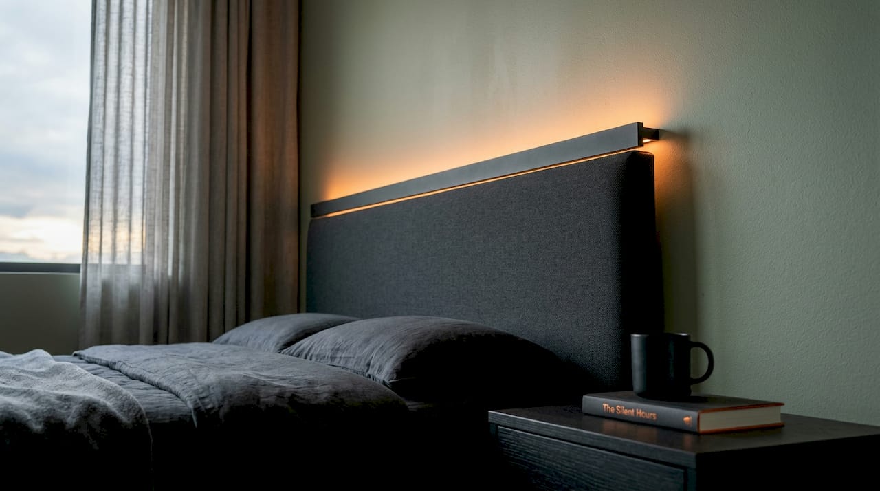 Hidden LED strip lighting detail behind bedroom headboard