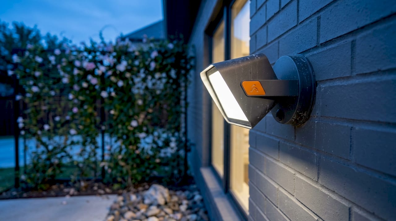 Neutral white LED security light fixture on stucco wall
