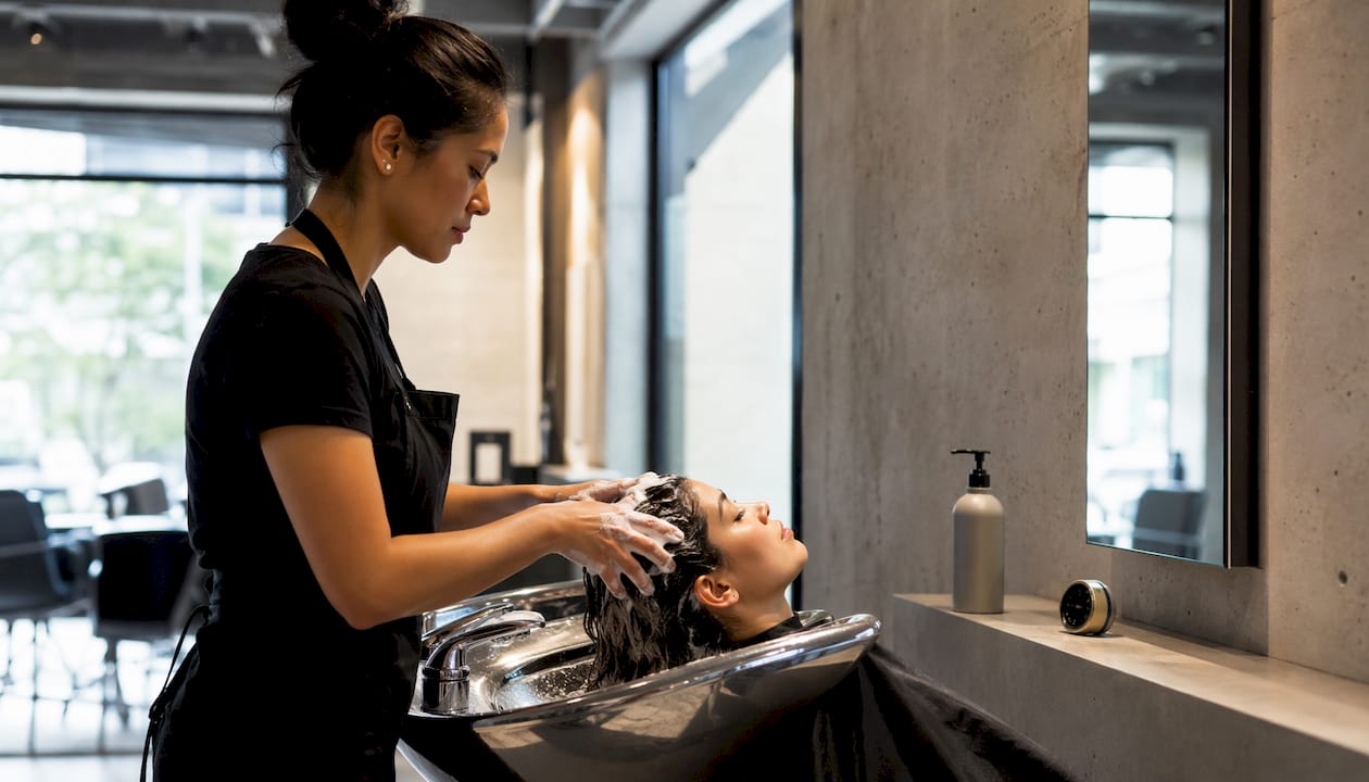 Hands washing hair with detox shampoo