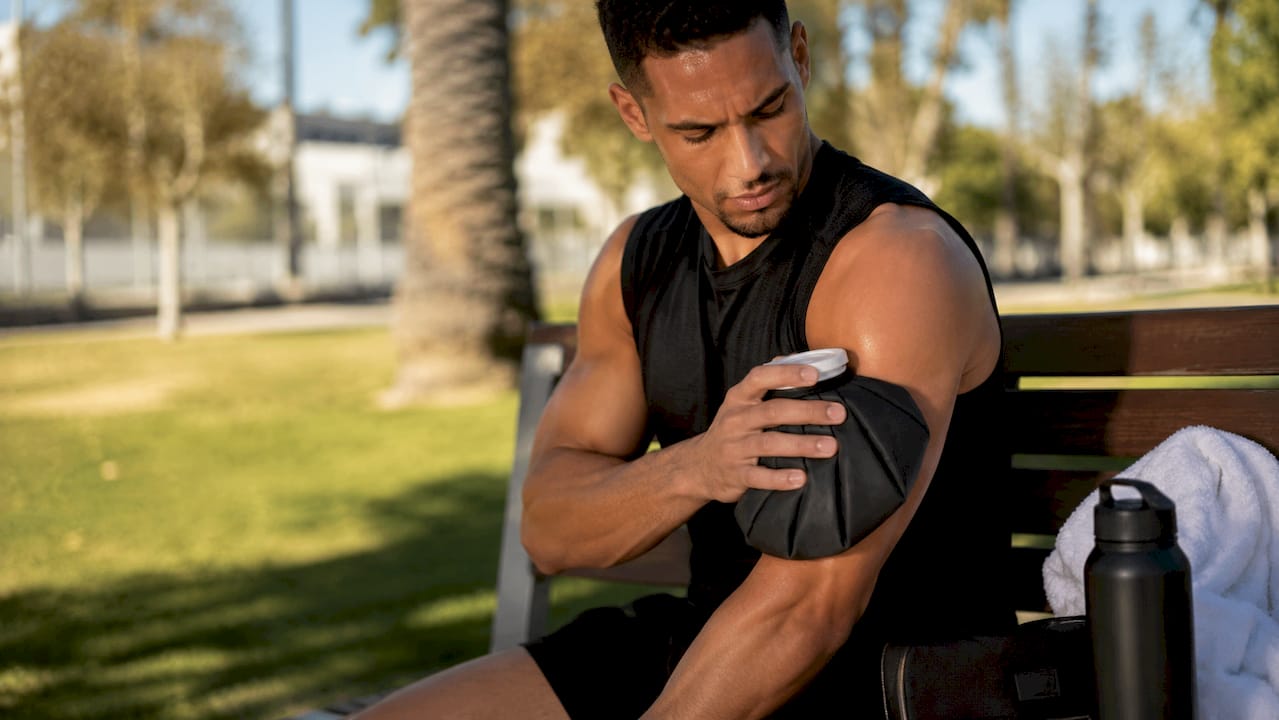 Athlete applying ice pack post-workout inflammation