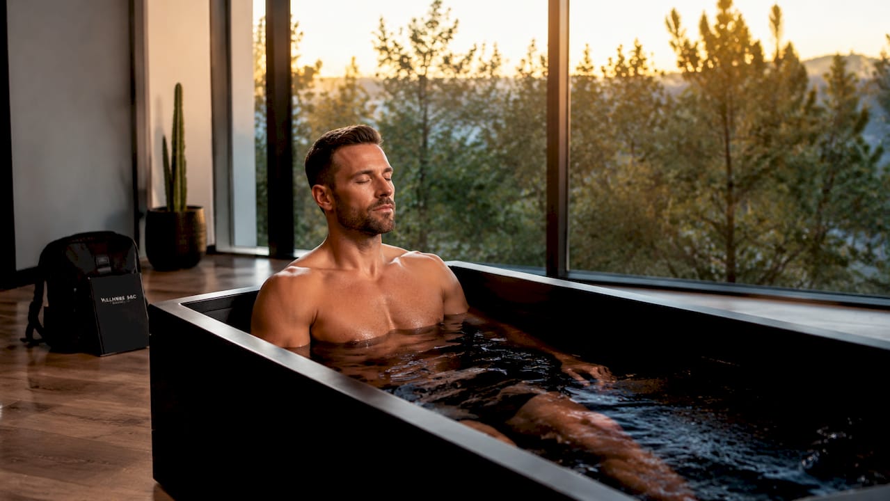 Athlete in cold plunge relaxing in wellness center
