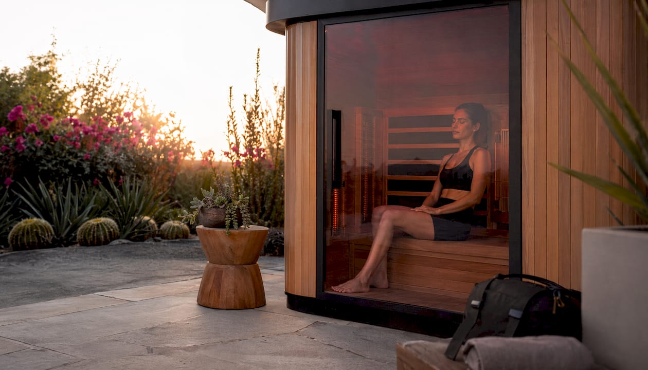 Woman relaxing in infrared sauna cabin