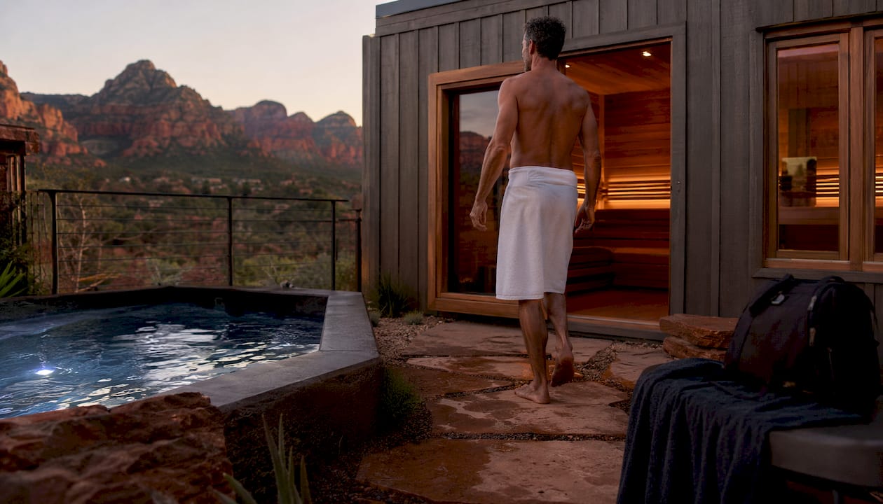 Man entering sauna and cold plunge recovery suite