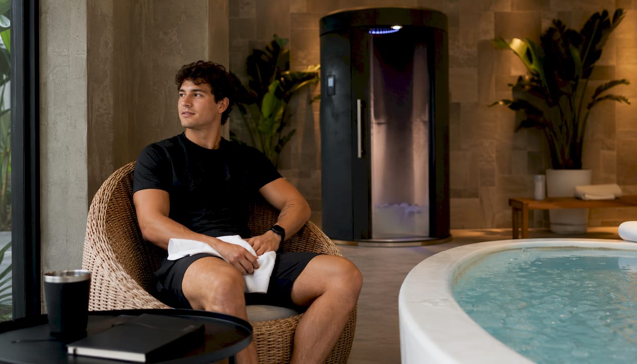 Athlete relaxing near cold plunge pool in spa