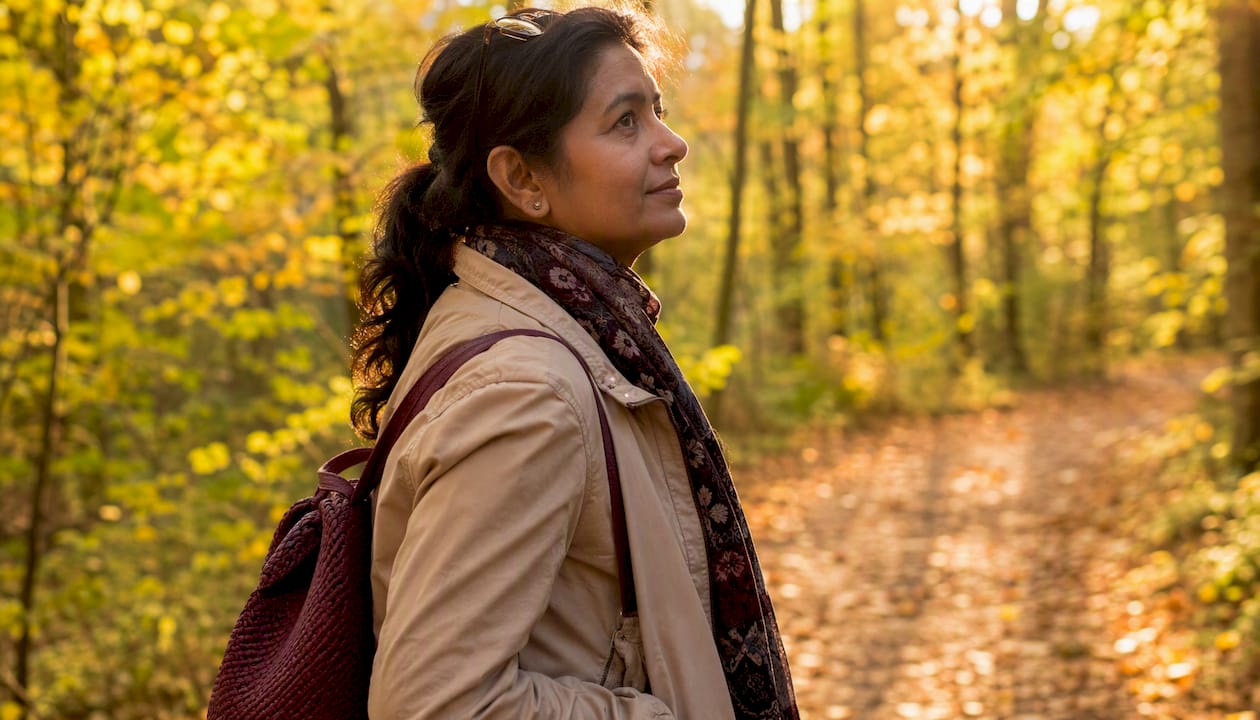 Elderly woman walking mindfully in park