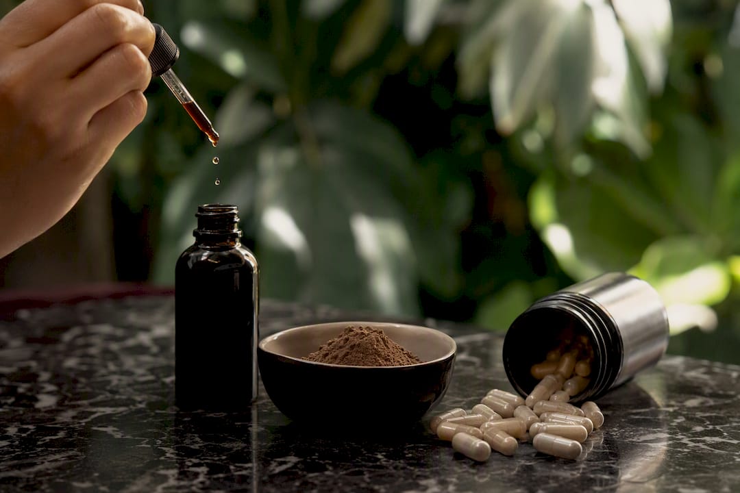 Capsules, tincture bottle, and powder forms of adaptogens