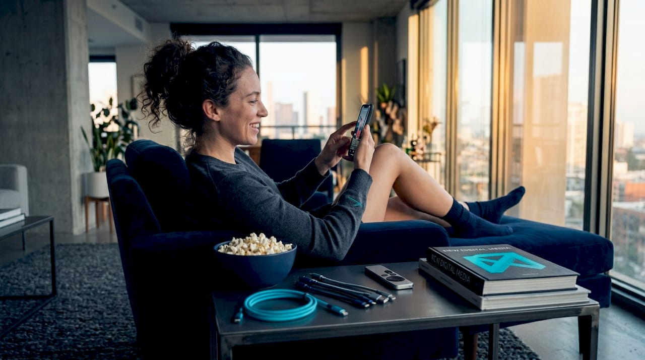 Woman scrolling vertical videos on sofa