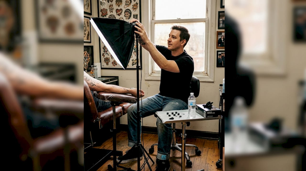 Tattoo artist setting up lighting in studio