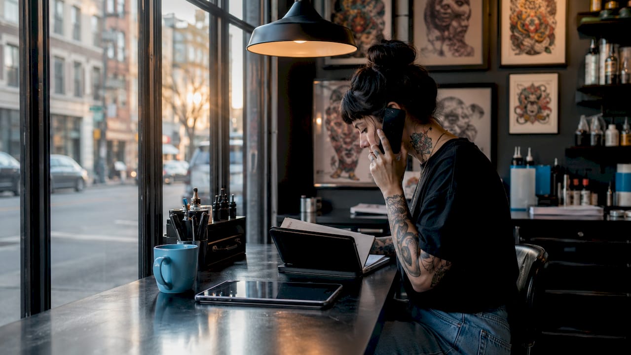 Tattoo artist scheduling client appointment