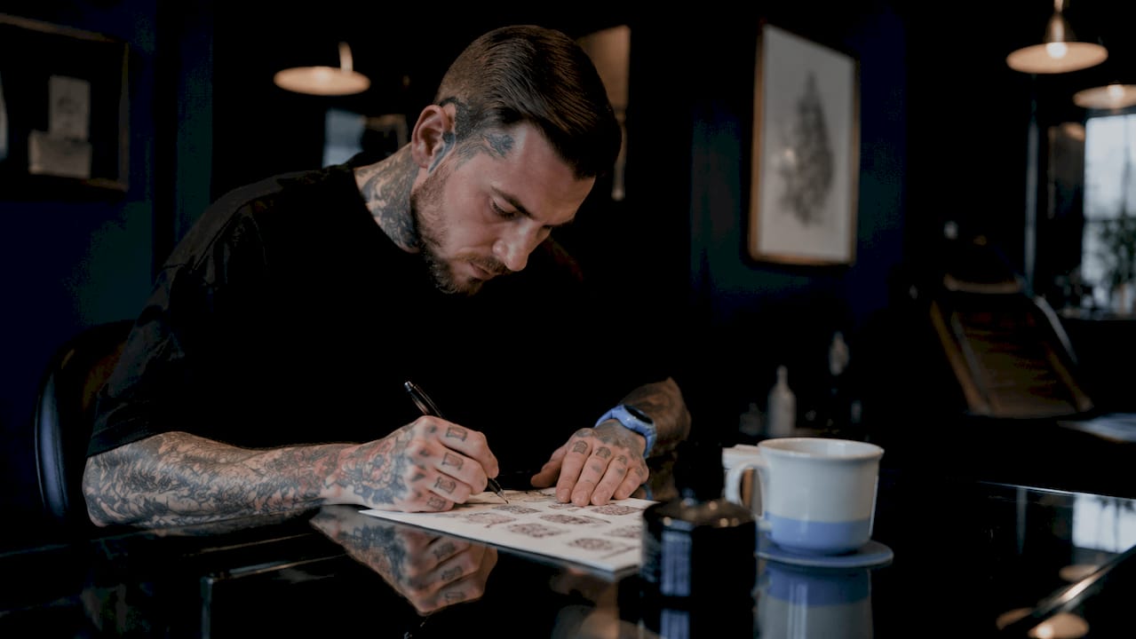 Tattoo artist writing tattoo guide
