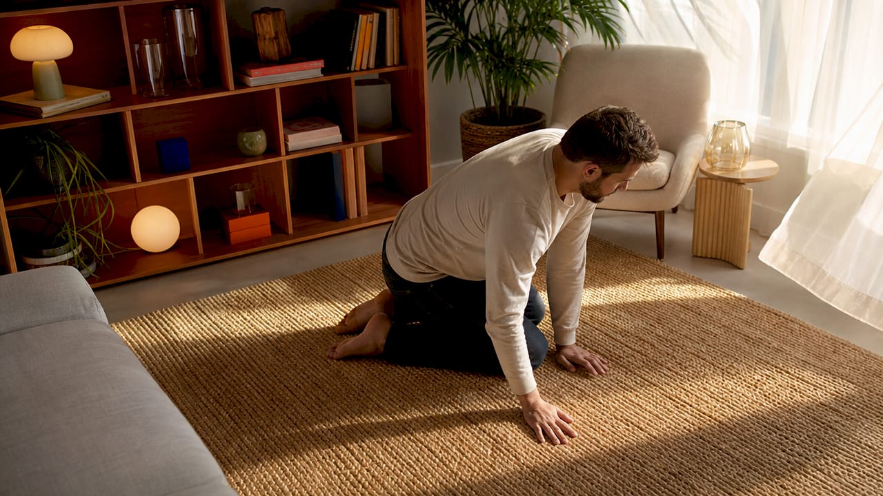 Hands touching natural fiber rug texture