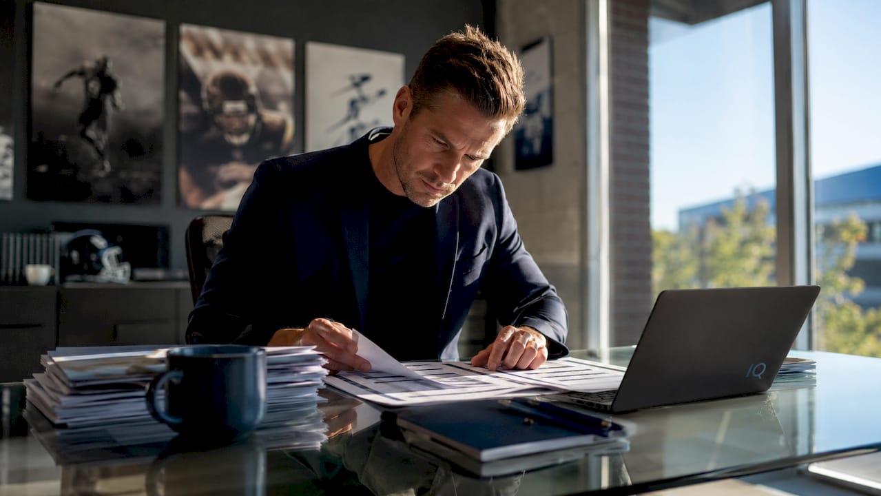 Athletic enrollment manager reviewing recruitment schedule