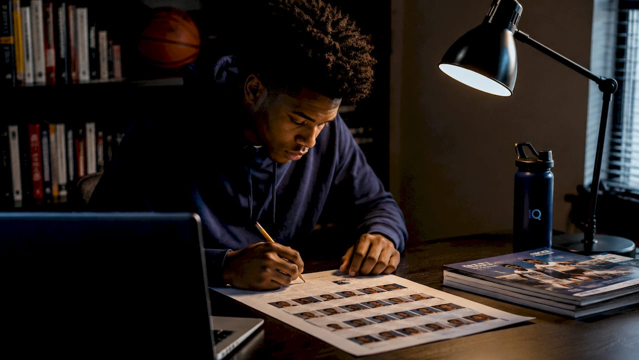 College basketball player analyzing team roster