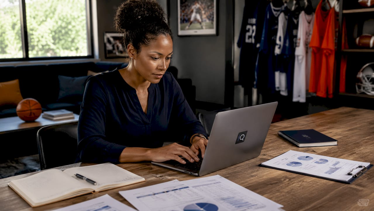 Female analyst working at athletic data desk