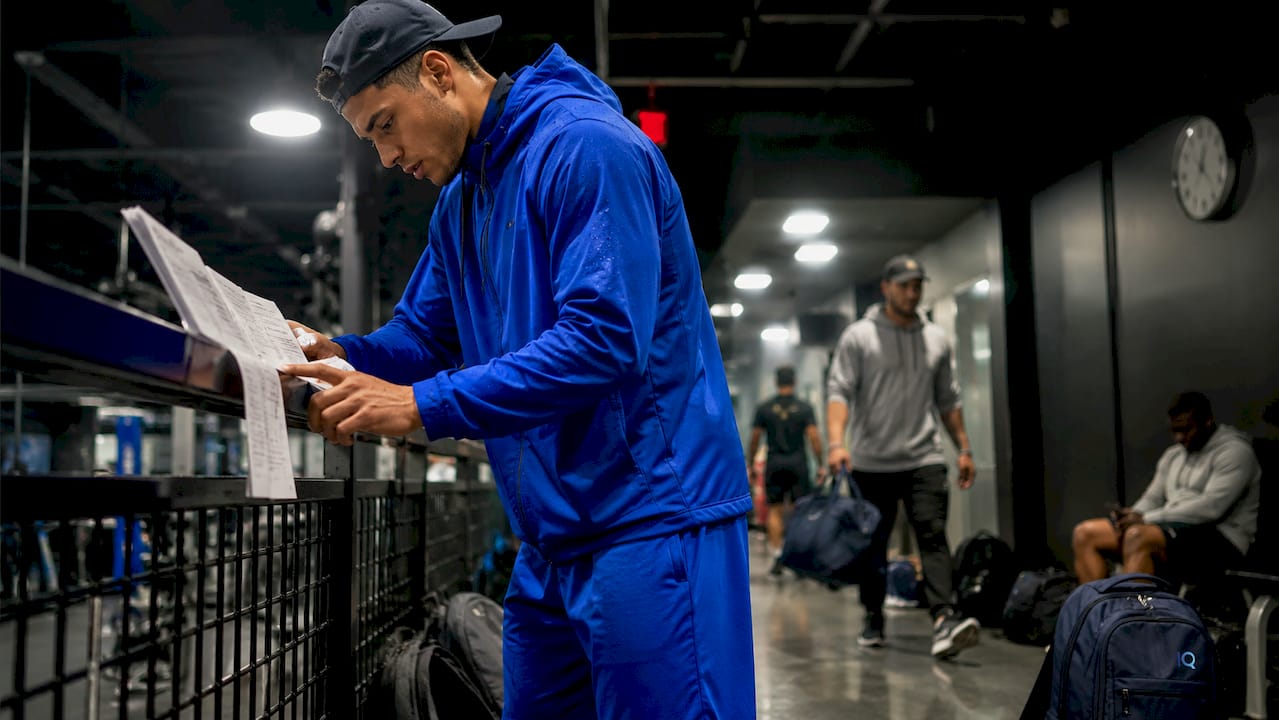 Athlete reviewing training program papers