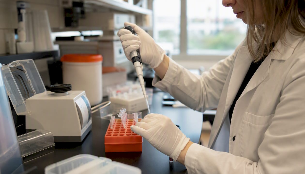 Scientist pipetting samples for RT-PCR validation