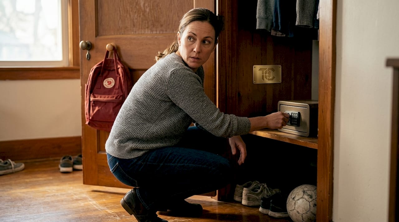 Woman securing firearm lockbox in bedroom closet