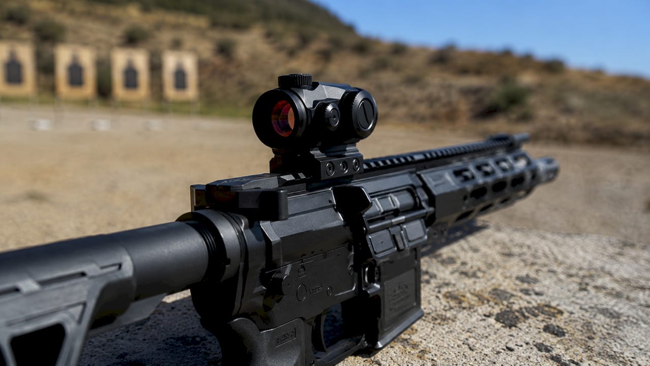 Close-up of rifle red dot sight on bench